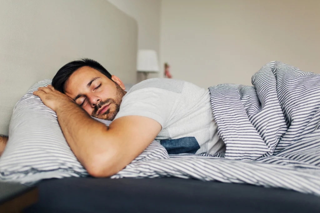 Young man sleeping deeply after taking qualia night supplements.