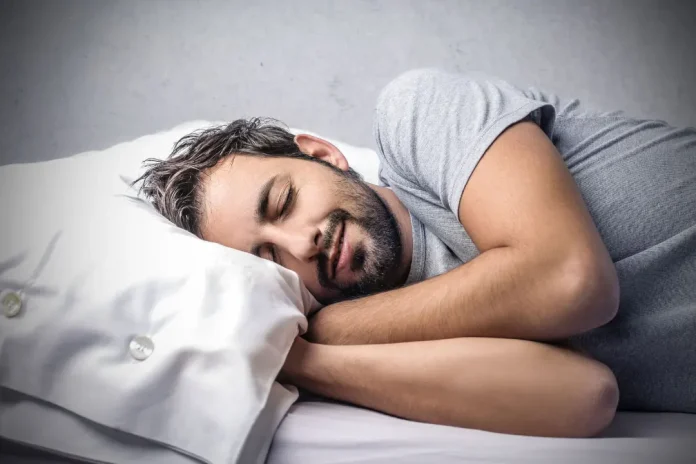 man sleeping on bed